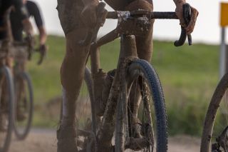 A rider almost completely obscured by mud at the 2023 Unbound 200